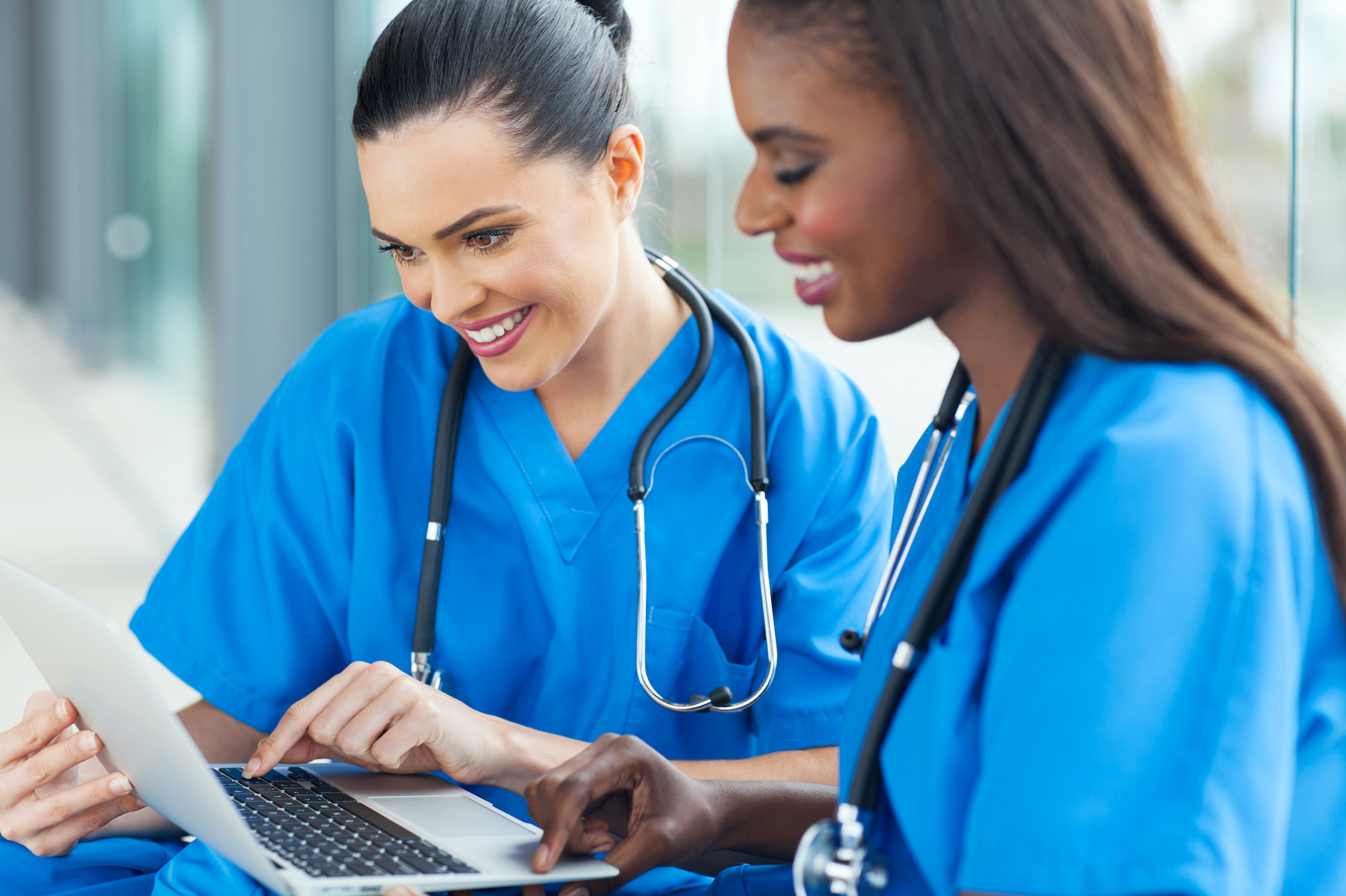 happy healthcare workers using laptop