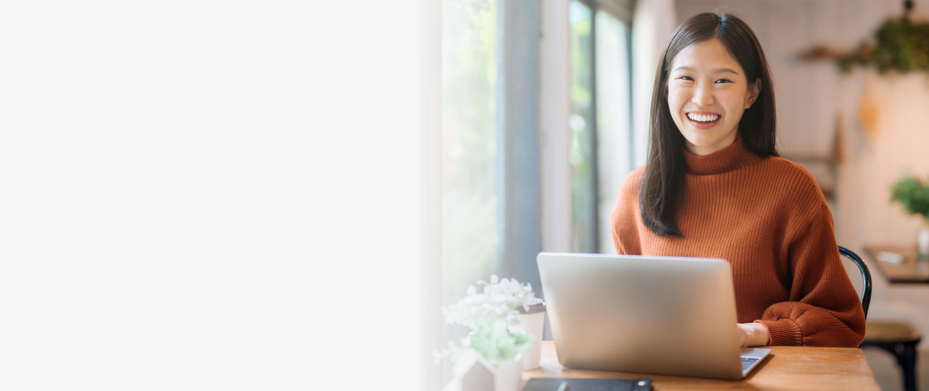 student on computer smiling