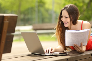 Paralegal student learning with a laptop and book